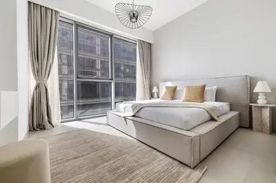 a bedroom with a bed and a large window at 2BR plus M CF7 B Partial Canal View in Dubai