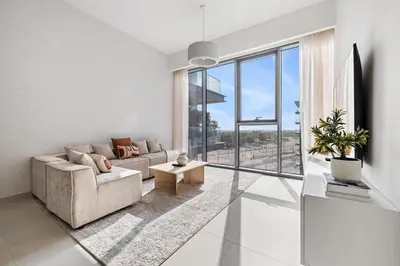 a living room with a couch and a large window at 2BR plus M CF7 B Partial Canal View in Dubai