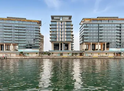 two tall buildings next to a body of water at 2BR plus M CF7 B Partial Canal View in Dubai