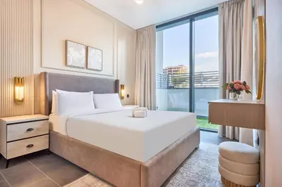 a hotel room with a bed and a large window at STAY BY LATINEM Luxury 1BR Holiday Home CB 0618 Near Burj Khalifa in Dubai
