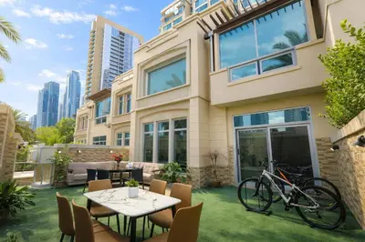 a house with a bicycle parked in the yard at Teremok Holiday Homes in Dubai