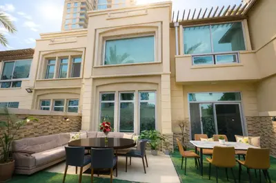 a house with a patio with a table and chairs at Teremok Holiday Homes in Dubai