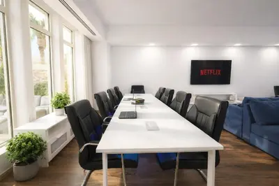 a meeting room with a long table and chairs at Teremok Holiday Homes in Dubai