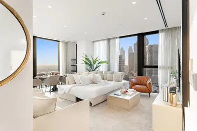a living room with a white couch and a table at Spacious 2BR in Business Bay with Canal View in Dubai