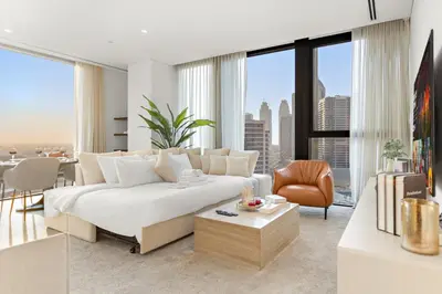 a living room with a white couch and a table at Spacious 2BR in Business Bay with Canal View in Dubai