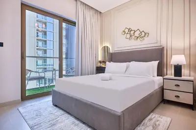 a bedroom with a large bed and a large window at STAY BY LATINEM Luxury 1BR Holiday Home CV A 907 near Dubai Mall in Dubai
