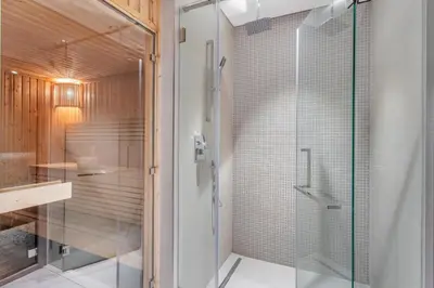 a bathroom with a shower with a glass door at STAY BY LATINEM Luxury 1BR Holiday Home CV A 907 near Dubai Mall in Dubai