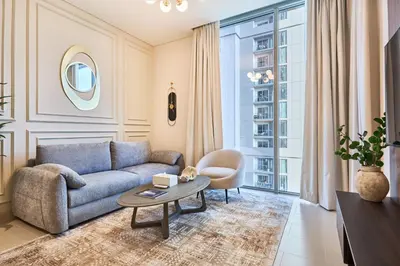 a living room with a couch and a table at STAY BY LATINEM Luxury 1BR Holiday Home CV A 907 near Dubai Mall in Dubai