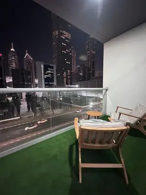 a room with a view of a city at night at Prime Apartments Near WTC and Sheikh Zayed RD in Dubai