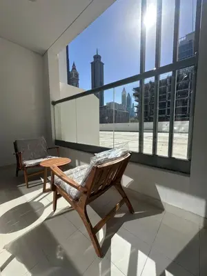 a room with two chairs and a large window at Prime Apartments Near WTC and Sheikh Zayed RD in Dubai