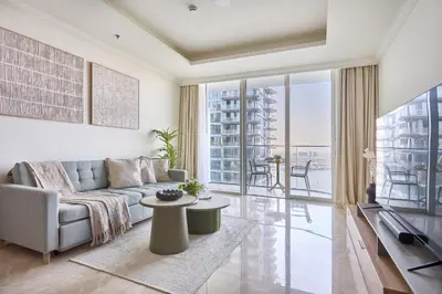 a living room with a couch and a table at Frank Porter - Palace Beach Residence in Dubai