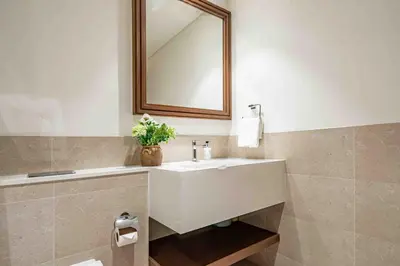 a bathroom with a white sink and a mirror at Frank Porter - Palace Beach Residence in Dubai