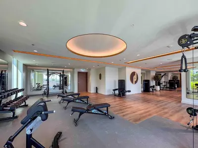 a gym with a bunch of treadmills and exercise bikes at Frank Porter - Palace Beach Residence in Dubai