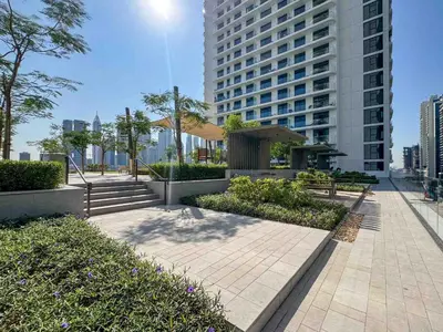 a park with a large building in the background at Frank Porter - Palace Beach Residence in Dubai