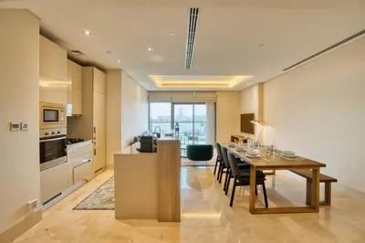 a kitchen and dining room with a table and chairs at PVH - The 8 - Opulent 3BR with Sea View and Private Beach Access in Dubai