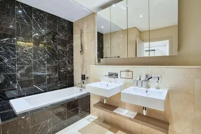 a bathroom with two sinks and a tub and a mirror at PVH - The 8 - Opulent 3BR with Sea View and Private Beach Access in Dubai