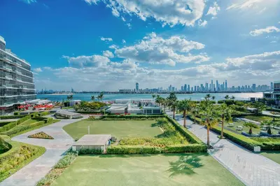 a view of a park with the city in the background at PVH - The 8 - Opulent 3BR with Sea View and Private Beach Access in Dubai