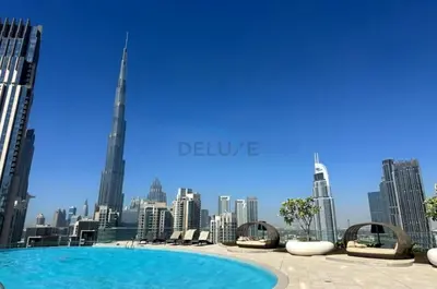 a swimming pool with a view of the city at High-Floor Balcony with Burj Khalifa View and Assistant Room, Minutes from Burj Plaza & Dubai Mall, Easy Access to Downtown Attractions, Imperial Avenue, Downtown Dubai by Deluxe Holiday Homes in Dubai