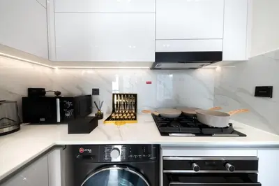 a kitchen with a stove and a stove top oven at Sleeps 4 I Circle Mall I Epic Pool in Dubai