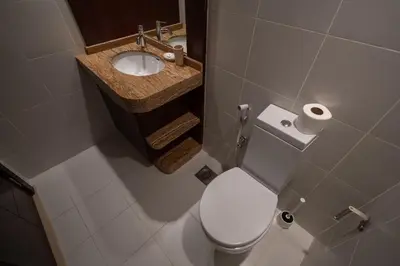 a bathroom with a white toilet and a sink at Downtown 1BHK apartment with City view in Dubai