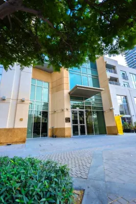 a large building with glass doors in front of it at Downtown 1BHK apartment with City view in Dubai