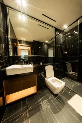 a bathroom with a sink and a toilet at Private Pool I Sleeps 6 I 5 Star Amenities I 2BR Onyx in Dubai