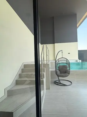 a wicker chair sitting on a porch next to some stairs at Private Pool I Sleeps 6 I 5 Star Amenities I 2BR Onyx in Dubai