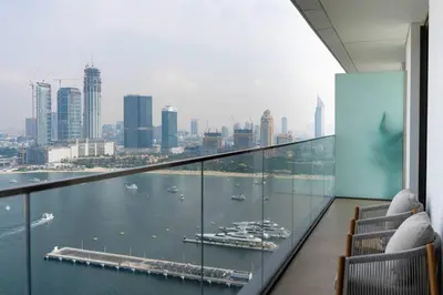 a balcony with a view of the water and a city at Dubai Harbour Marina View with Beach Access in Dubai