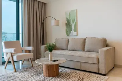 a living room with a couch and a table at Dubai Harbour Marina View with Beach Access in Dubai