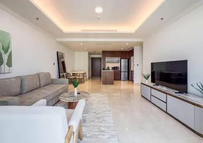 a living room with a couch and a flat screen tv at Dubai Harbour Marina View with Beach Access in Dubai
