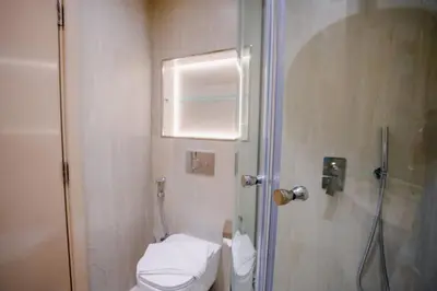 a small bathroom with a toilet and a shower at Sunny Studio - Dubai Marina - Close Beach in Dubai