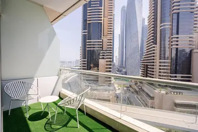 a balcony with chairs and a view of a city at Sunny Studio - Dubai Marina - Close Beach in Dubai