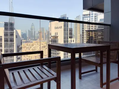 a table and chairs on a balcony with a view of the city at Elite Downtown Residence, Downtown Dubai - Onelink in Dubai