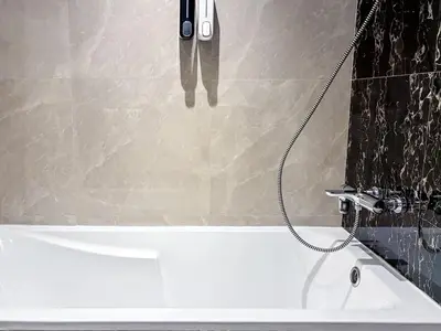 a bath tub in a bathroom with a shower at Elite Downtown Residence, Downtown Dubai - Onelink in Dubai