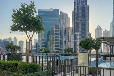 a view of a city skyline with a swimming pool at 3Min to Dubai mall and Burj Khalifa, Luxury 1B and Amenities in Dubai
