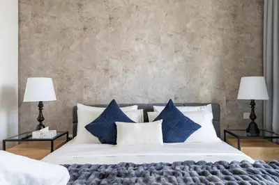 a bedroom with a large bed with blue pillows at 3Min to Dubai mall and Burj Khalifa, Luxury 1B and Amenities in Dubai
