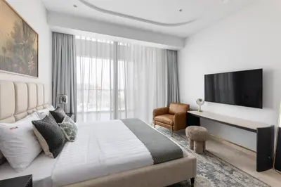 a hotel room with a bed and a television at Exclusive 2BR Residence on Palm Jumeirah - Beach Access in Dubai