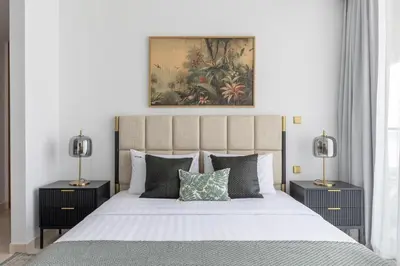 a bedroom with a large bed with two lamps at Exclusive 2BR Residence on Palm Jumeirah - Beach Access in Dubai
