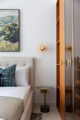 a bedroom with a bed and a table at Exclusive 2BR Residence on Palm Jumeirah - Beach Access in Dubai