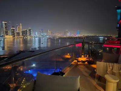 a balcony with a view of a city at night at Top Floor Penthouse In Oceana With Panoramic Views in Dubai