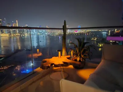 a balcony with a table and a view of a city at Top Floor Penthouse In Oceana With Panoramic Views in Dubai