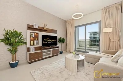a living room with a television and a couch at Oversized 1BR Apartment Near Dubai Hills Mall in Dubai