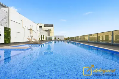 a large swimming pool on the roof of a building at Oversized 1BR Apartment Near Dubai Hills Mall in Dubai
