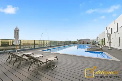 a swimming pool on the roof of a building at Oversized 1BR Apartment Near Dubai Hills Mall in Dubai