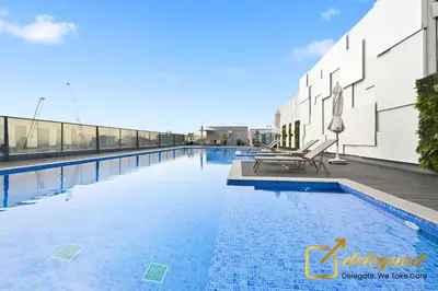 a swimming pool on the roof of a building at Elite Studio in Dubai Hills Near Dubai Hills Mall in Dubai