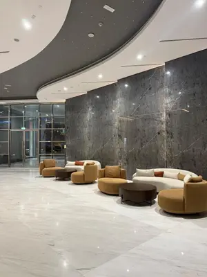 a lobby with couches and tables in a building at Flat 1BR Business Bay the bay in Dubai