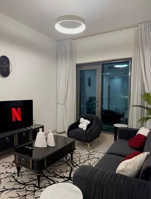 a living room with a couch and a table at Flat 1BR Business Bay the bay in Dubai