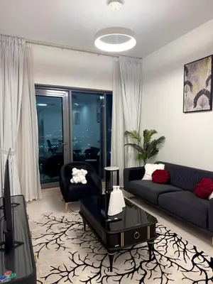 a living room with a couch and a table at Flat 1BR Business Bay the bay in Dubai