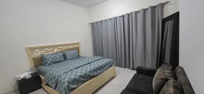 a bedroom with a bed and a window and a couch at Luxury Master Bed Room With Attached Bathroom in Dubai