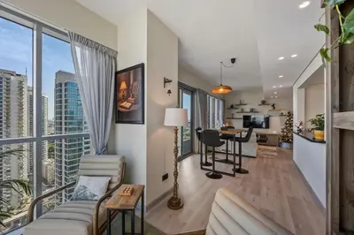 a living room with a couch and a table at Nonna house Stylish 1BR and Panoramic Studio, City, Golf, Lake view in Dubai